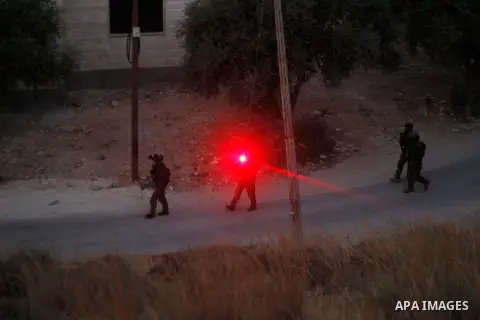 Israeli forces patrol near the house where Palestinian Mohammad al-Fakih was shot dead by Israeli troops during a raid in the West Bank village of Surif, near Hebron July 27, 2016. Photo by Wisam Hashlamoun