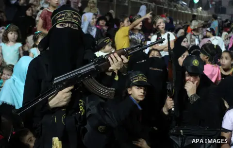 Palestinian female militants from the Al-Quds Brigades, the armed wing of the Islamic Jihad movement, take part in a rally in Rafah in the southern Gaza Strip on July 28, 2016. Photo by Abed Rahim Khatib