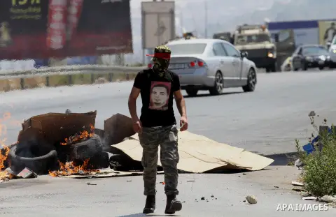 Palestinian activists from the Popular Front of the Liberation of Palestine (PFLP) demonstrate at the Hawara checkpoint near the West Bank city of Nablus on July 29, 2016, against the detention of Bilal Kayed, a fellow P...