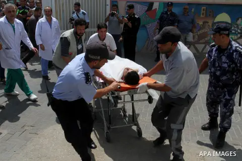 Palestinian rescue workers take part in an emergency simulation exercise in the border city of Rafah, in the southern Gaza Strip, on August 1, 2016. Photo by Abed Rahim Khatib