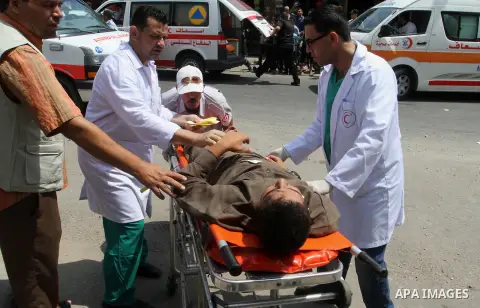 Palestinian rescue workers take part in an emergency simulation exercise in the border city of Rafah, in the southern Gaza Strip, on August 1, 2016. Photo by Abed Rahim Khatib