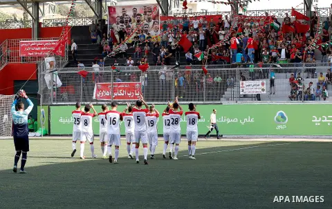 Fans of Hebron's football club Ahly al-Khalil cheer before a second leg match against Shabab Khan Yunis for the Palestinian Cup final on August 2, 2016 at Hussein Bin Ali Stadium in the West Bank city of Hebron. The matc...