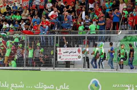 Fans of Hebron's football club Ahly al-Khalil cheer before a second leg match against Shabab Khan Yunis for the Palestinian Cup final on August 2, 2016 at Hussein Bin Ali Stadium in the West Bank city of Hebron. The matc...