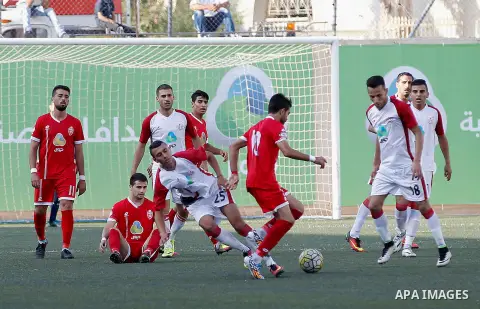 Ahly al-Khalil players and Shabab Khan Yunis players compete during thier a second leg match for the Palestinian Cup final on August 2, 2016 at Hussein Bin Ali Stadium in the West Bank city of Hebron. The match had origi...