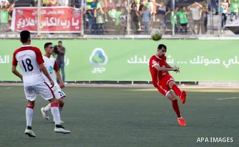 Ahly al-Khalil players and Shabab Khan Yunis players compete during thier a second leg match for the Palestinian Cup final on August 2, 2016 at Hussein Bin Ali Stadium in the West Bank city of Hebron. The match had origi...