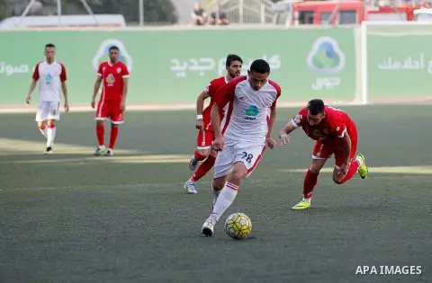Ahly al-Khalil players and Shabab Khan Yunis players compete during thier a second leg match for the Palestinian Cup final on August 2, 2016 at Hussein Bin Ali Stadium in the West Bank city of Hebron. The match had origi...