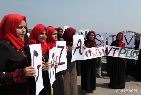 Palestinian girls hold banners during a protest to mark the second anniversary of the 50-day Israeli war on Gaza Strip last summer, in Gaza seaport Aug. 03, 2016. July 8th marks the two-year anniversary of the war betwee...