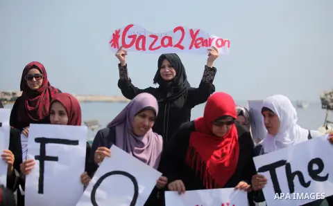Palestinian girls hold banners during a protest to mark the second anniversary of the 50-day Israeli war on Gaza Strip last summer, in Gaza seaport Aug. 03, 2016. July 8th marks the two-year anniversary of the war betwee...