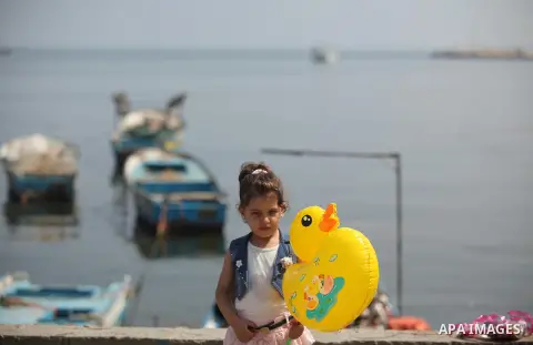 Palestinian girls hold banners during a protest to mark the second anniversary of the 50-day Israeli war on Gaza Strip last summer, in Gaza seaport Aug. 03, 2016. July 8th marks the two-year anniversary of the war betwee...