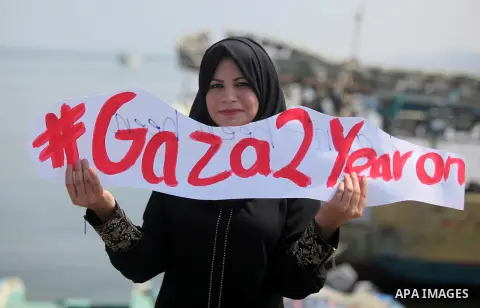 Palestinian girls hold banners during a protest to mark the second anniversary of the 50-day Israeli war on Gaza Strip last summer, in Gaza seaport Aug. 03, 2016. July 8th marks the two-year anniversary of the war betwee...