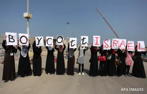 Palestinian girls hold banners during a protest to mark the second anniversary of the 50-day Israeli war on Gaza Strip last summer, in Gaza seaport Aug. 03, 2016. July 8th marks the two-year anniversary of the war betwee...