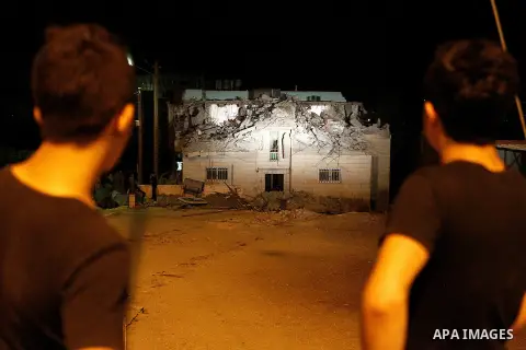 Palestinians inspect the damage after Israeli troops demolished the family house of Palestinian assailant Khalid Makhamreh in the West Bank village of Yatta, south of Hebron August 4, 2016. Photo by Wisam Hashlamoun