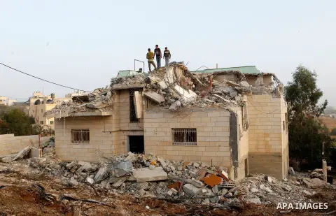 Palestinians inspect the damage after Israeli troops demolished the family house of Palestinian assailant Khalid Makhamreh in the West Bank village of Yatta, south of Hebron August 4, 2016. Photo by Wisam Hashlamoun