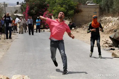 Palestinian protestors throw stones towards Israeli security forces during clashes following the weekly demonstration against the expropriation of Palestinian land by Israel in the village of Kfar Qaddum, near Nablus, in...