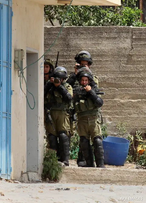 Israeli security forces take pictures during clashes with Palestinian protesters following the weekly demonstration against the expropriation of Palestinian land by Israel in the village of Kfar Qaddum, near Nablus, in t...