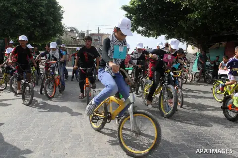 Palestinian children take part in the bicycles marathon to demand their right to play and break the siege on Gaza strip, in Rafah in the southern Gaza Strip. on August 7, 2016. Photo by Abed Rahim Khatib