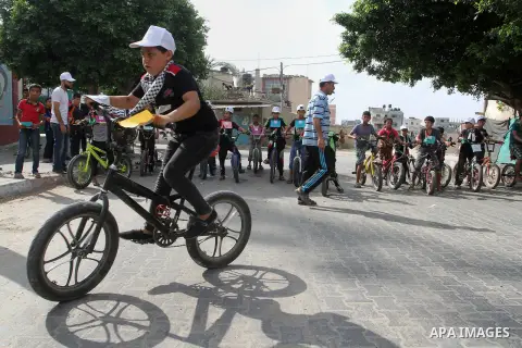 Palestinian children take part in the bicycles marathon to demand their right to play and break the siege on Gaza strip, in Rafah in the southern Gaza Strip. on August 7, 2016. Photo by Abed Rahim Khatib