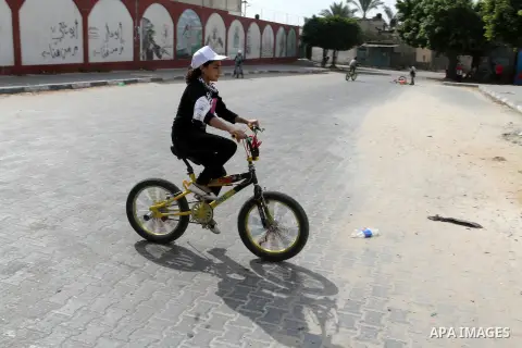Palestinian children take part in the bicycles marathon to demand their right to play and break the siege on Gaza strip, in Rafah in the southern Gaza Strip. on August 7, 2016. Photo by Abed Rahim Khatib