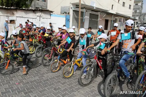 Palestinian children take part in the bicycles marathon to demand their right to play and break the siege on Gaza strip, in Rafah in the southern Gaza Strip. on August 7, 2016. Photo by Abed Rahim Khatib