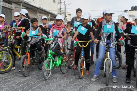 Palestinian children take part in the bicycles marathon to demand their right to play and break the siege on Gaza strip, in Rafah in the southern Gaza Strip. on August 7, 2016. Photo by Abed Rahim Khatib