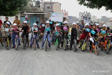 Palestinian children take part in the bicycles marathon to demand their right to play and break the siege on Gaza strip, in Rafah in the southern Gaza Strip. on August 7, 2016. Photo by Abed Rahim Khatib