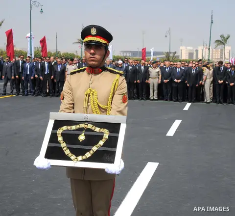 An officer carries the Order of the Grand Collar of the Nile, Egypt's highest state honour which was given before to Egyptian-American Ahmed Zewail world's Nobel Prize in chemistry, who died last Tuesday for 70 years in...