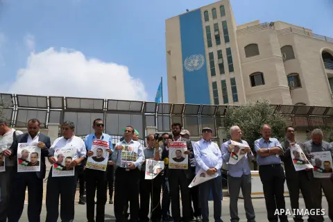Palestinians take part during a protest calling for the release of Palestinian journalist Omar Nazzal and Bilal Kayed a Palestinian prisoner on hunger strike, in front of UN headquarters in the West Bank city of Ramallah...