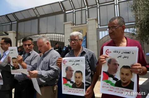 Palestinians take part during a protest calling for the release of Palestinian journalist Omar Nazzal and Bilal Kayed a Palestinian prisoner on hunger strike, in front of UN headquarters in the West Bank city of Ramallah...