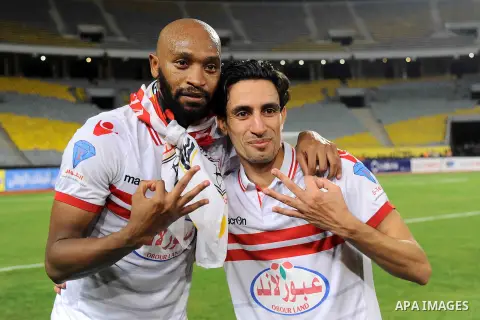 Zamalek players celebrate with the trophy after winning their Egyptian Cup finals derby soccer match against Al Ahly in Borg El-Arab Stadium near Alexandria, Egypt, Aug 8,2016. Photo by Stringer