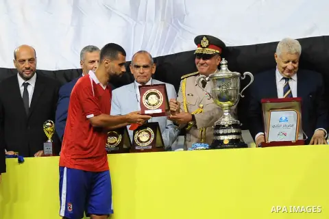 Zamalek players celebrate with the trophy after winning their Egyptian Cup finals derby soccer match against Al Ahly in Borg El-Arab Stadium near Alexandria, Egypt, Aug 8,2016. Photo by Stringer