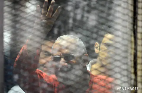 Egyptian Muslim Brotherhood defendants are seen behind bars during their trial, in a case known in media as "Rabaa Operations Room", in Cairo, on Aug. 09, 2016. Photo by Amr Sayed