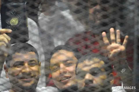 Egyptian Muslim Brotherhood defendants are seen behind bars during their trial, in a case known in media as "Rabaa Operations Room", in Cairo, on Aug. 09, 2016. Photo by Amr Sayed