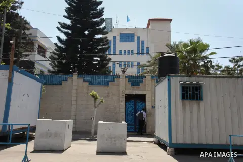 Palestinian staff of the United Nations Development Programme (UNDP) are seen in front of its headquarters in Gaza City on August 10, 2016. Israel said it had arrested and charged a United Nations employee for allegedly...