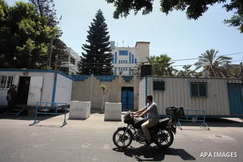 A Palestinian man rides a motorcycle in front of its headquarters in Gaza City on August 10, 2016. Israel said it had arrested and charged a United Nations employee for allegedly aiding Islamist movement Hamas, in the se...