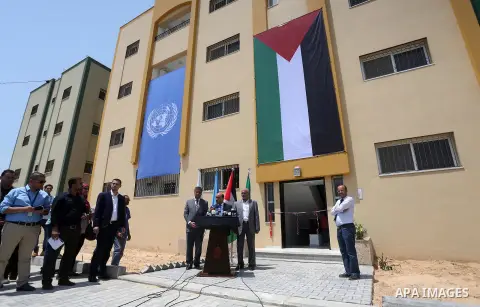 Palestinian Minister of public works and housing, Mofeed al-Hasayna, speaks during a distribution ceremony the 40 housing units funded by the Saudi Fund for the Palestinians, whose house was destroyed by what witnesses s...