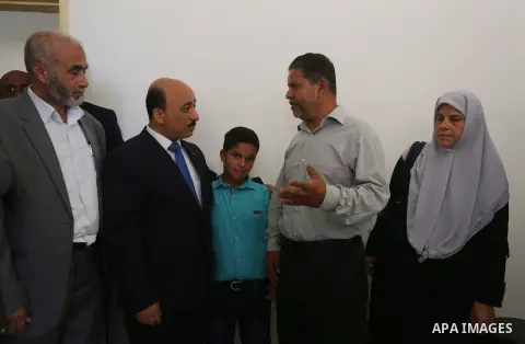 Palestinian Minister of public works and housing, Mofeed al-Hasayna, attends the distribution ceremony the 40 housing units funded by the Saudi Fund for the Palestinians, whose house was destroyed by what witnesses said...