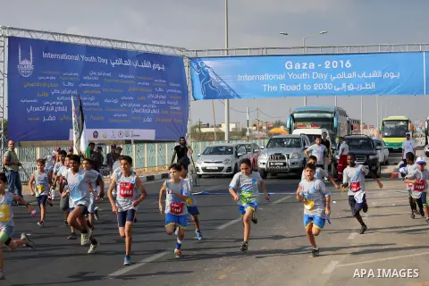 Palestinian children take part in a marathon to mark the International Youth Day, in Gaza city, on Aug. 12, 2016. Photo by Mohammed Asad