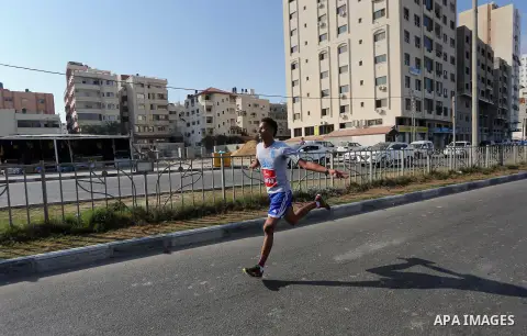 Palestinian youths take part in a marathon to mark the International Youth Day, in Gaza city, on Aug. 12, 2016. Photo by Mohammed Asad