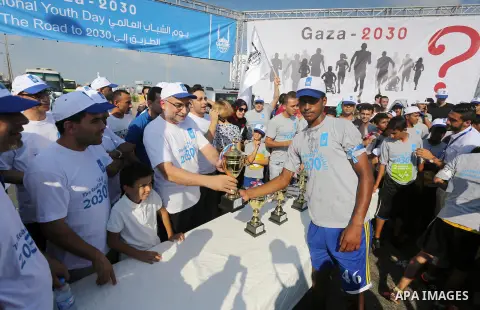 Palestinian youths take part in a marathon to mark the International Youth Day, in Gaza city, on Aug. 12, 2016. Photo by Mohammed Asad