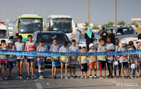 Palestinian children take part in a marathon to mark the International Youth Day, in Gaza city, on Aug. 12, 2016. Photo by Mohammed Asad