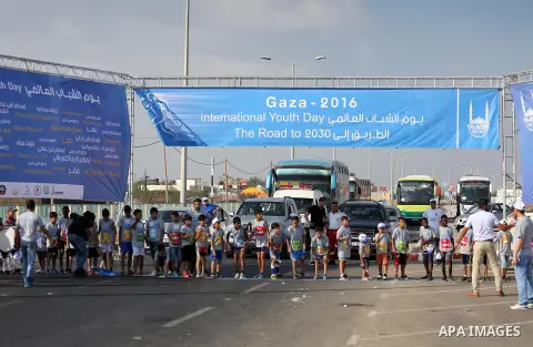 Palestinian children take part in a marathon to mark the International Youth Day, in Gaza city, on Aug. 12, 2016. Photo by Mohammed Asad