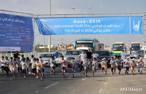 Palestinian children take part in a marathon to mark the International Youth Day, in Gaza city, on Aug. 12, 2016. Photo by Mohammed Asad