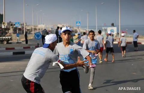 Palestinian youths take part in a marathon to mark the International Youth Day, in Gaza city, on Aug. 12, 2016. Photo by Mohammed Asad