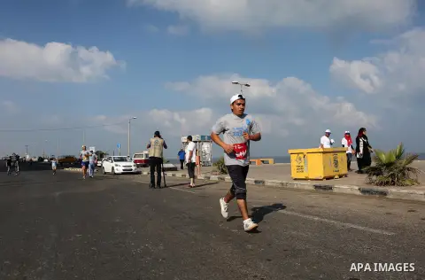 Palestinian youths take part in a marathon to mark the International Youth Day, in Gaza city, on Aug. 12, 2016. Photo by Mohammed Asad