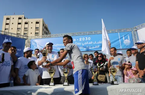 Palestinian youths take part in a marathon to mark the International Youth Day, in Gaza city, on Aug. 12, 2016. Photo by Mohammed Asad