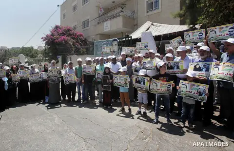 Palestinian protestors hold posters against administrative detention and in support of Palestinian prisoner Bilal Kayed (portrait), who has been fasting for almost two months over his detention without trial, as they dem...