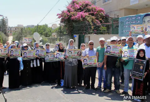 Palestinian protestors hold posters against administrative detention and in support of Palestinian prisoner Bilal Kayed (portrait), who has been fasting for almost two months over his detention without trial, as they dem...