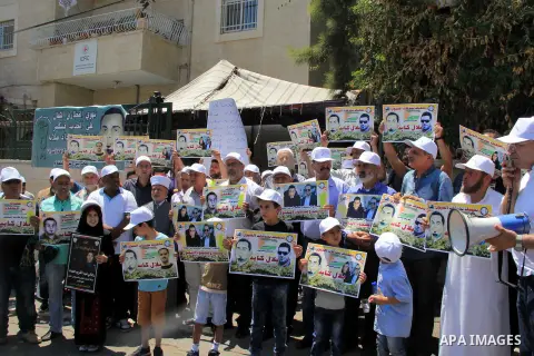Palestinian protestors hold posters against administrative detention and in support of Palestinian prisoner Bilal Kayed (portrait), who has been fasting for almost two months over his detention without trial, as they dem...