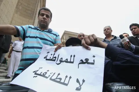 Egyptian Christians hold banners during a protest against Copts in Minya, in front of the High Court in Cairo, Egypt, on August 13, 2016. Photo by Amr Sayed