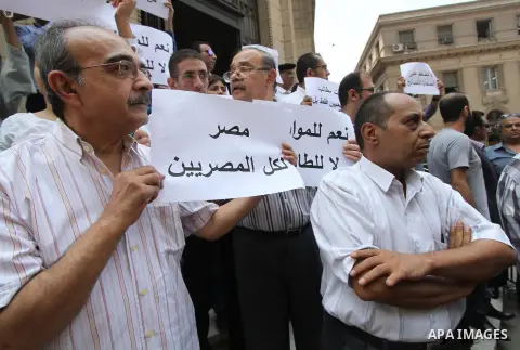 Egyptian Christians hold banners during a protest against Copts in Minya, in front of the High Court in Cairo, Egypt, on August 13, 2016. Photo by Amr Sayed